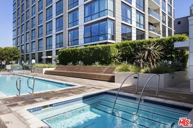 view of swimming pool featuring a community hot tub