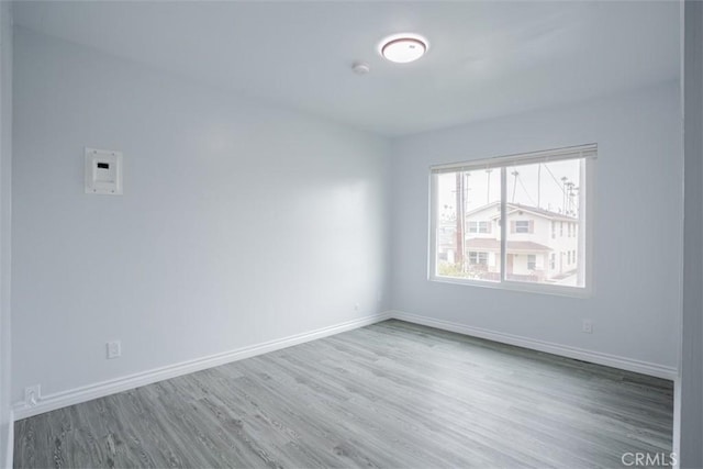 spare room featuring wood-type flooring