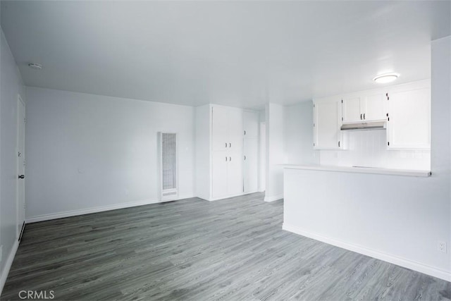 unfurnished living room with dark hardwood / wood-style floors