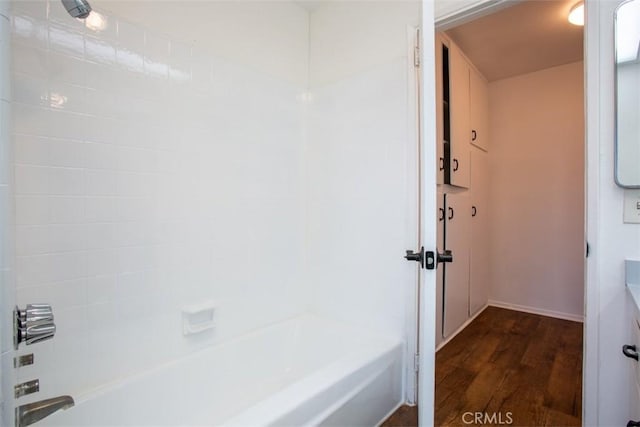 bathroom featuring wood-type flooring and bathtub / shower combination