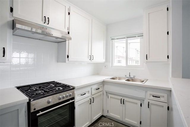 kitchen featuring white cabinets, sink, tasteful backsplash, and stainless steel range with gas stovetop