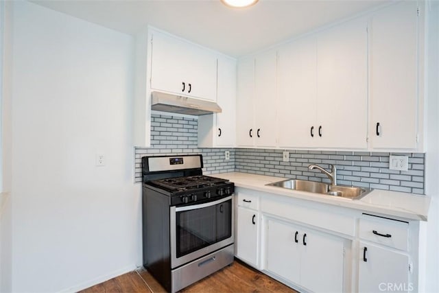 kitchen featuring gas stove, wood-type flooring, sink, and white cabinetry