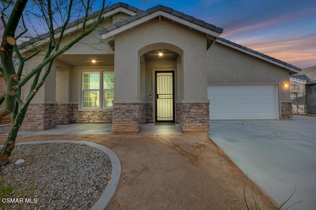 exterior entry at dusk with a garage