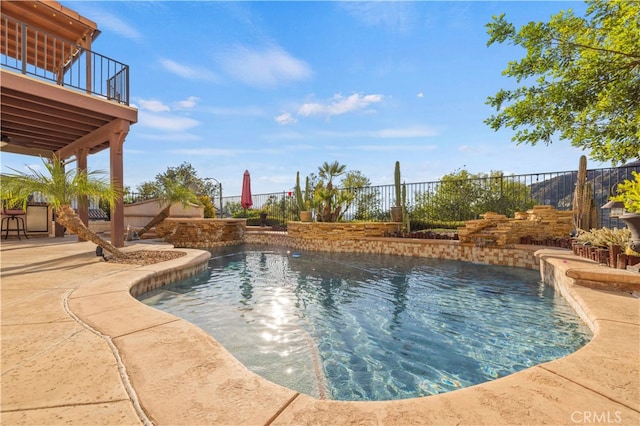 view of swimming pool featuring pool water feature and a patio