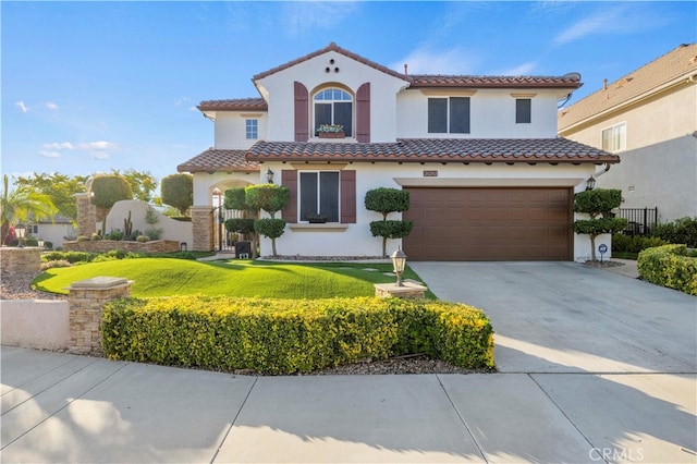 mediterranean / spanish house with a garage and a front lawn