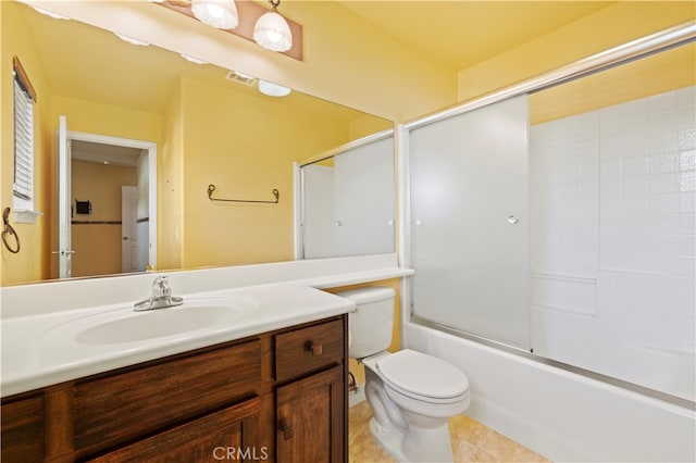 full bathroom featuring combined bath / shower with glass door, vanity, toilet, and tile patterned floors