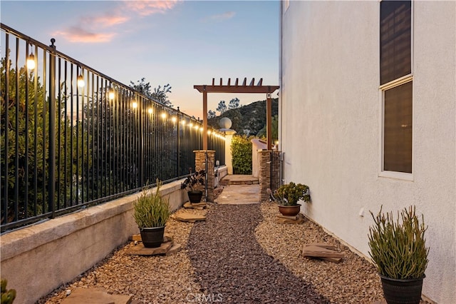 yard at dusk with a pergola