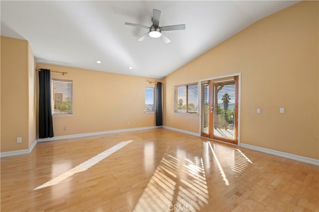 unfurnished room with ceiling fan, light hardwood / wood-style flooring, and lofted ceiling