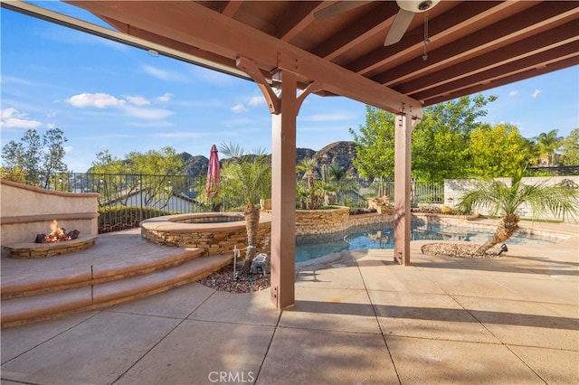 view of patio / terrace featuring a fenced in pool and a fire pit