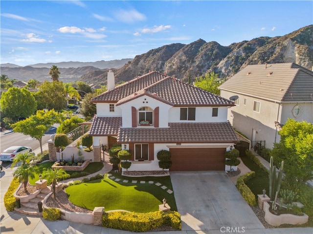 mediterranean / spanish home featuring a mountain view and a garage