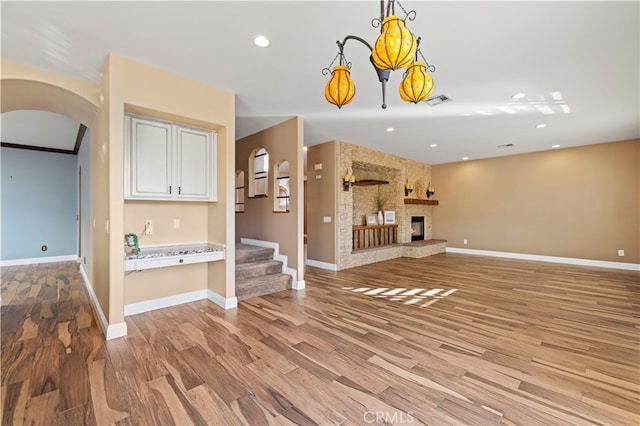 unfurnished living room featuring light hardwood / wood-style floors and a fireplace