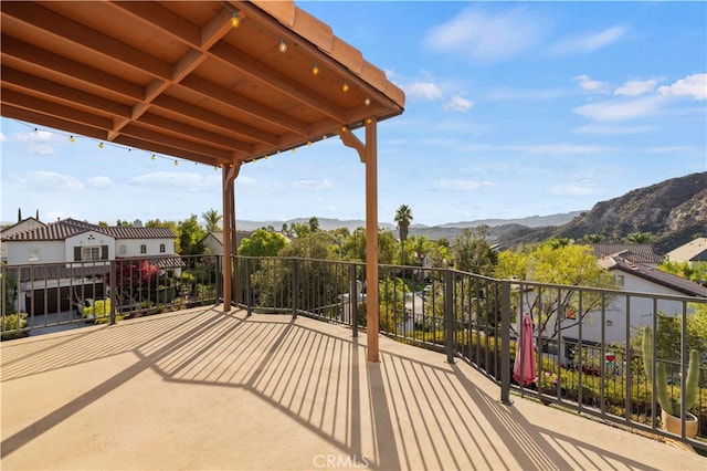 exterior space with a balcony and a mountain view