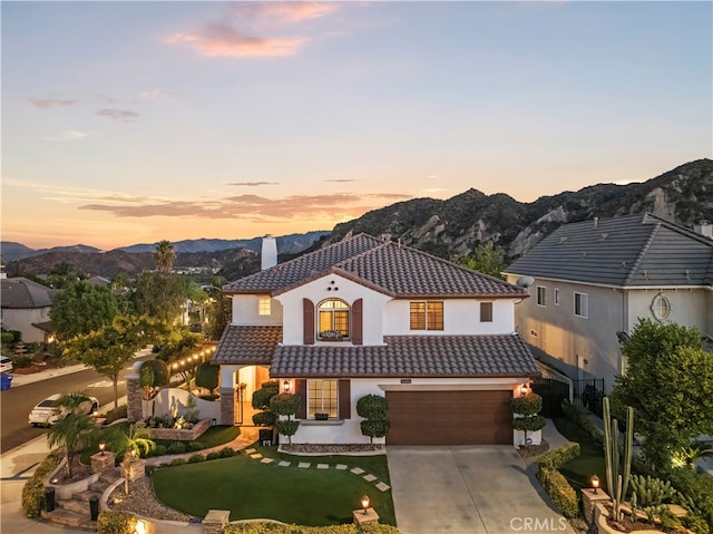 mediterranean / spanish-style home with a mountain view and a garage