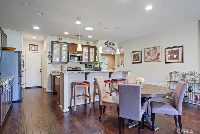 dining area with dark hardwood / wood-style floors