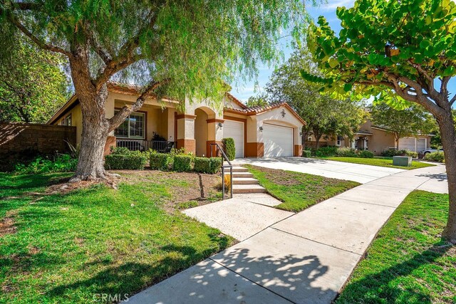 view of front of home with a front yard and a garage