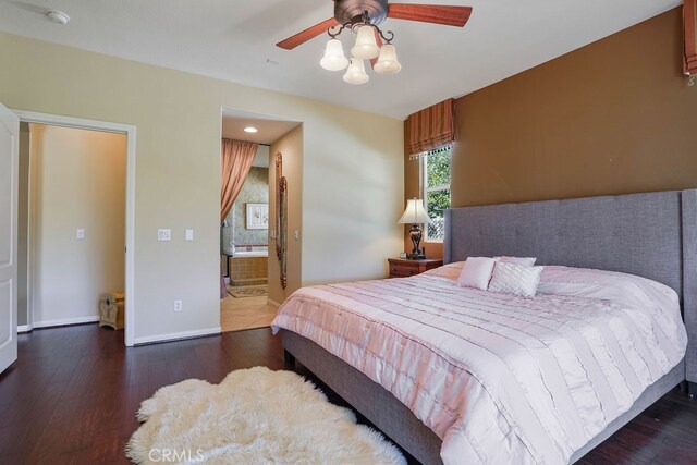 bedroom featuring ceiling fan, dark wood-type flooring, and connected bathroom