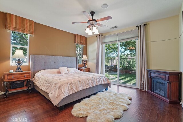 bedroom with ceiling fan, dark wood-type flooring, and access to outside