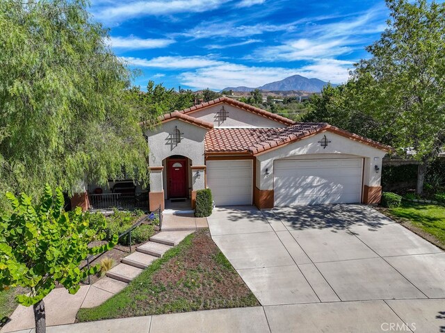 mediterranean / spanish house featuring a mountain view and a garage