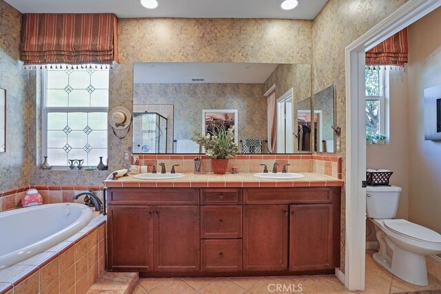 full bathroom featuring tile patterned flooring, plus walk in shower, vanity, and toilet