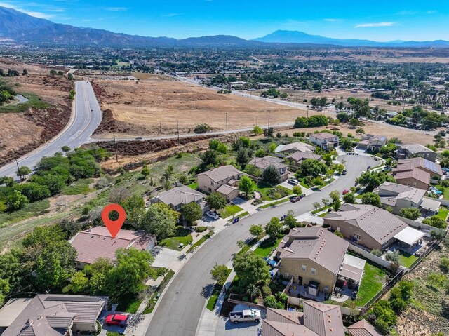 birds eye view of property featuring a mountain view