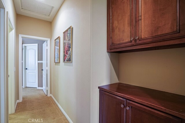 hallway with light colored carpet