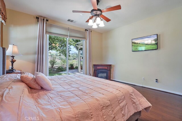 bedroom featuring access to outside, hardwood / wood-style flooring, and ceiling fan