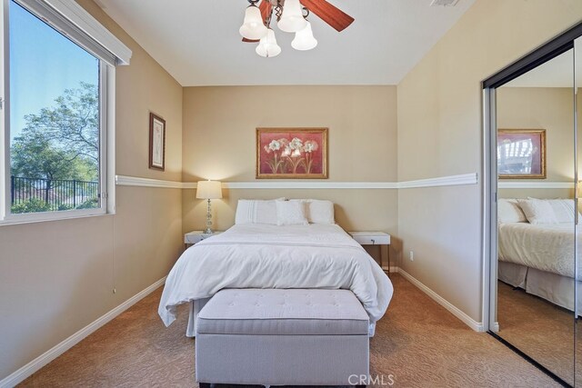 bedroom featuring ceiling fan and light carpet