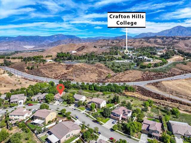 birds eye view of property with a mountain view