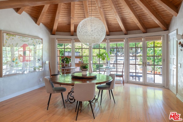 sunroom featuring vaulted ceiling with beams, a healthy amount of sunlight, a chandelier, and wooden ceiling