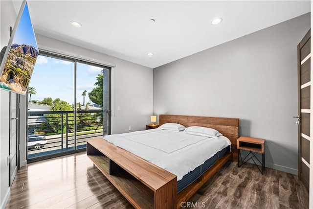 bedroom featuring dark wood-type flooring and access to outside