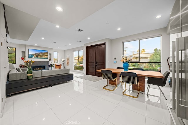 living room featuring light tile patterned floors and a tiled fireplace