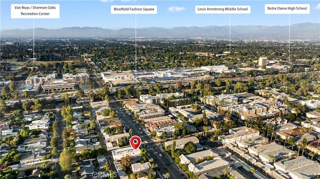 birds eye view of property with a mountain view