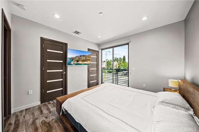 bedroom featuring access to exterior and hardwood / wood-style flooring