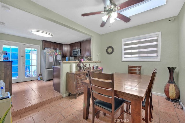 dining room featuring light tile patterned flooring, ceiling fan, and french doors