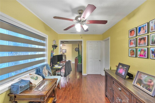 office space featuring ceiling fan, ornamental molding, and dark wood-type flooring