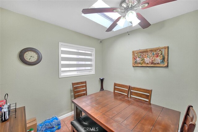 tiled dining room featuring ceiling fan