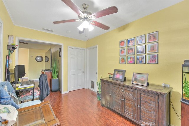 office with ornamental molding, ceiling fan, and hardwood / wood-style floors