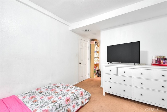 bedroom featuring light carpet