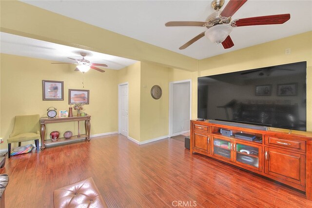 living room featuring ceiling fan and hardwood / wood-style flooring