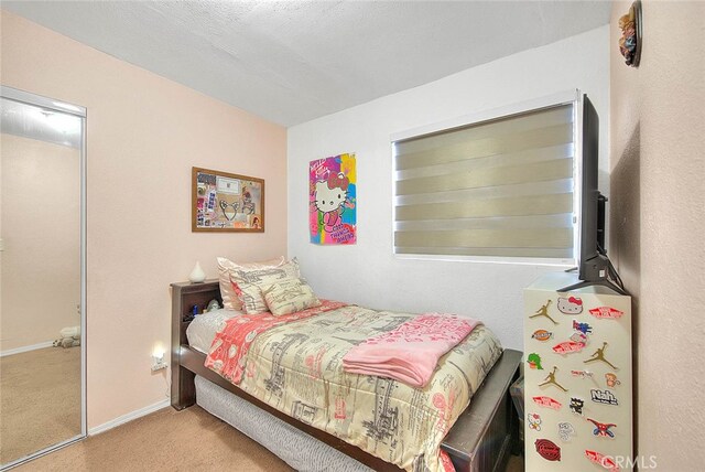 carpeted bedroom with a textured ceiling