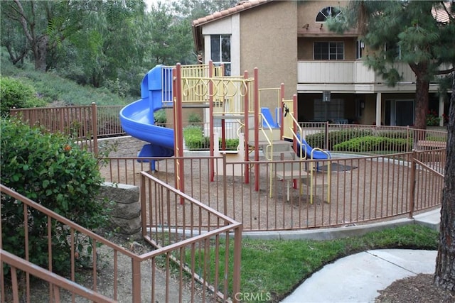 community jungle gym featuring fence