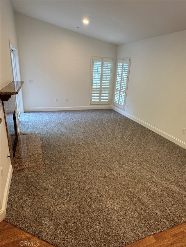 spare room featuring baseboards, carpet flooring, and recessed lighting