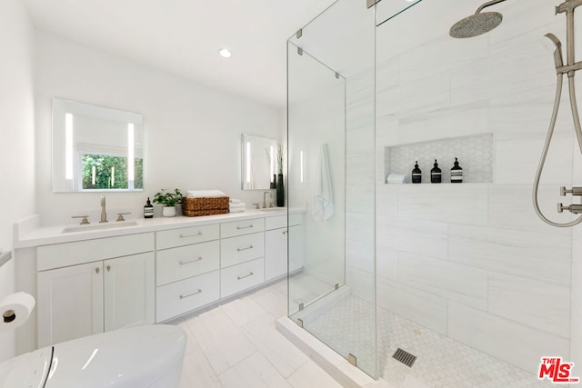 bathroom featuring vanity and tiled shower