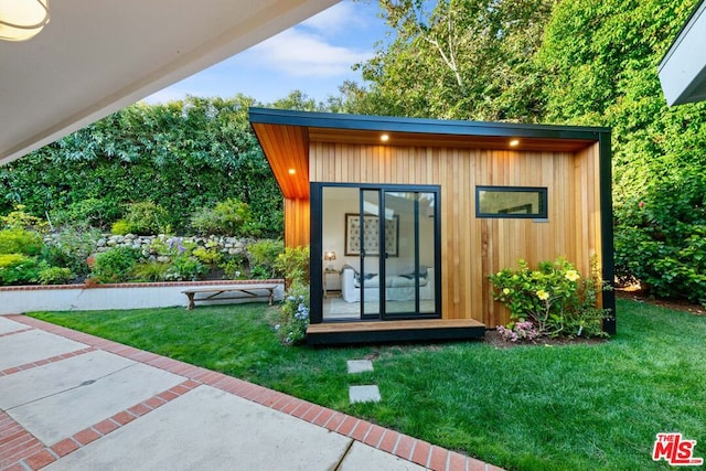 view of outdoor structure with a lawn