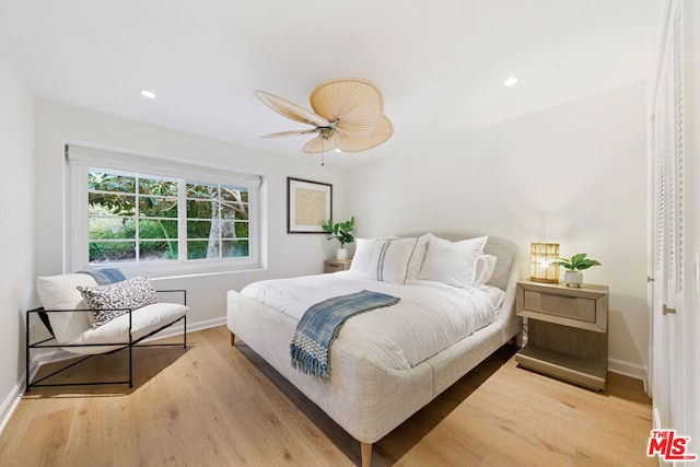 bedroom with light hardwood / wood-style flooring and ceiling fan