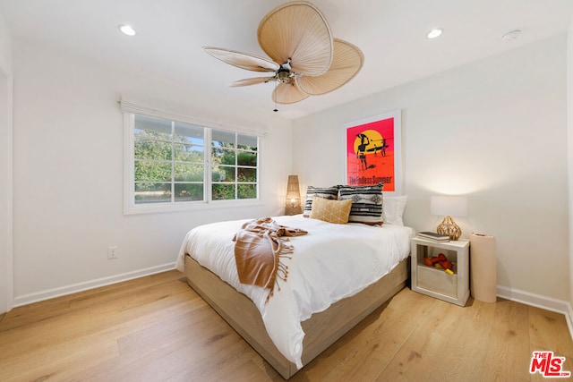 bedroom with ceiling fan and light hardwood / wood-style flooring