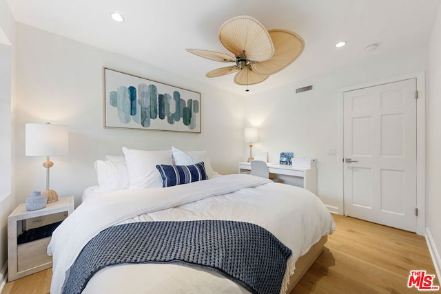 bedroom with ceiling fan and light wood-type flooring