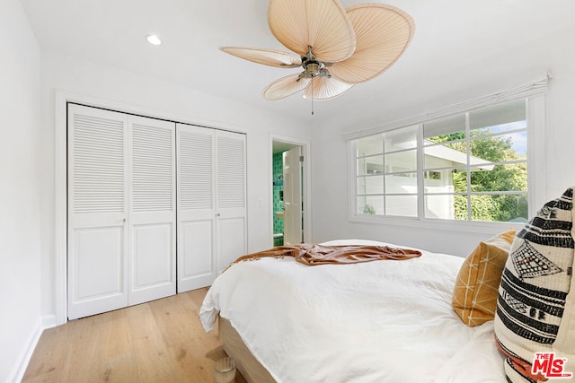 bedroom with ceiling fan, a closet, and light wood-type flooring