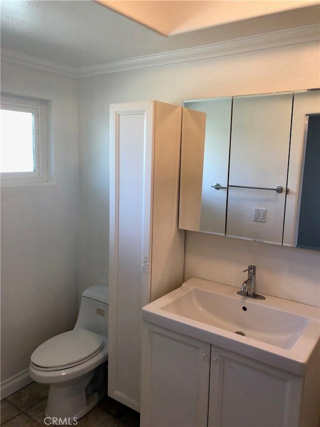 bathroom featuring tile patterned floors, vanity, ornamental molding, and toilet