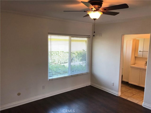 spare room with crown molding, hardwood / wood-style floors, and ceiling fan